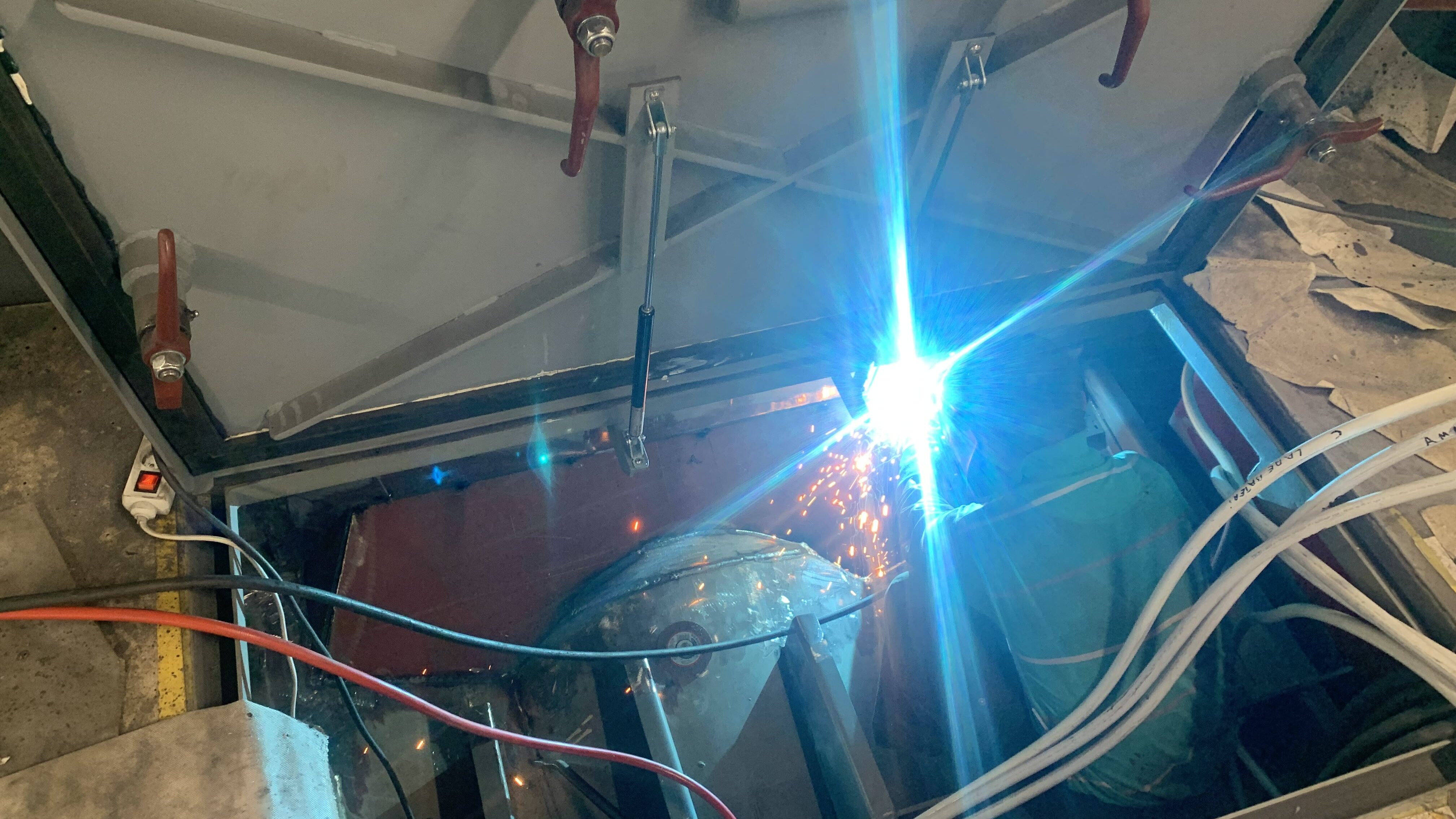 Hot work during vessel refit Hot work during a yacht refit highlighting marine insurance and project risk management.